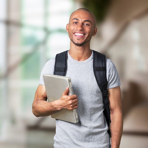 Smiling young black college student with laptop